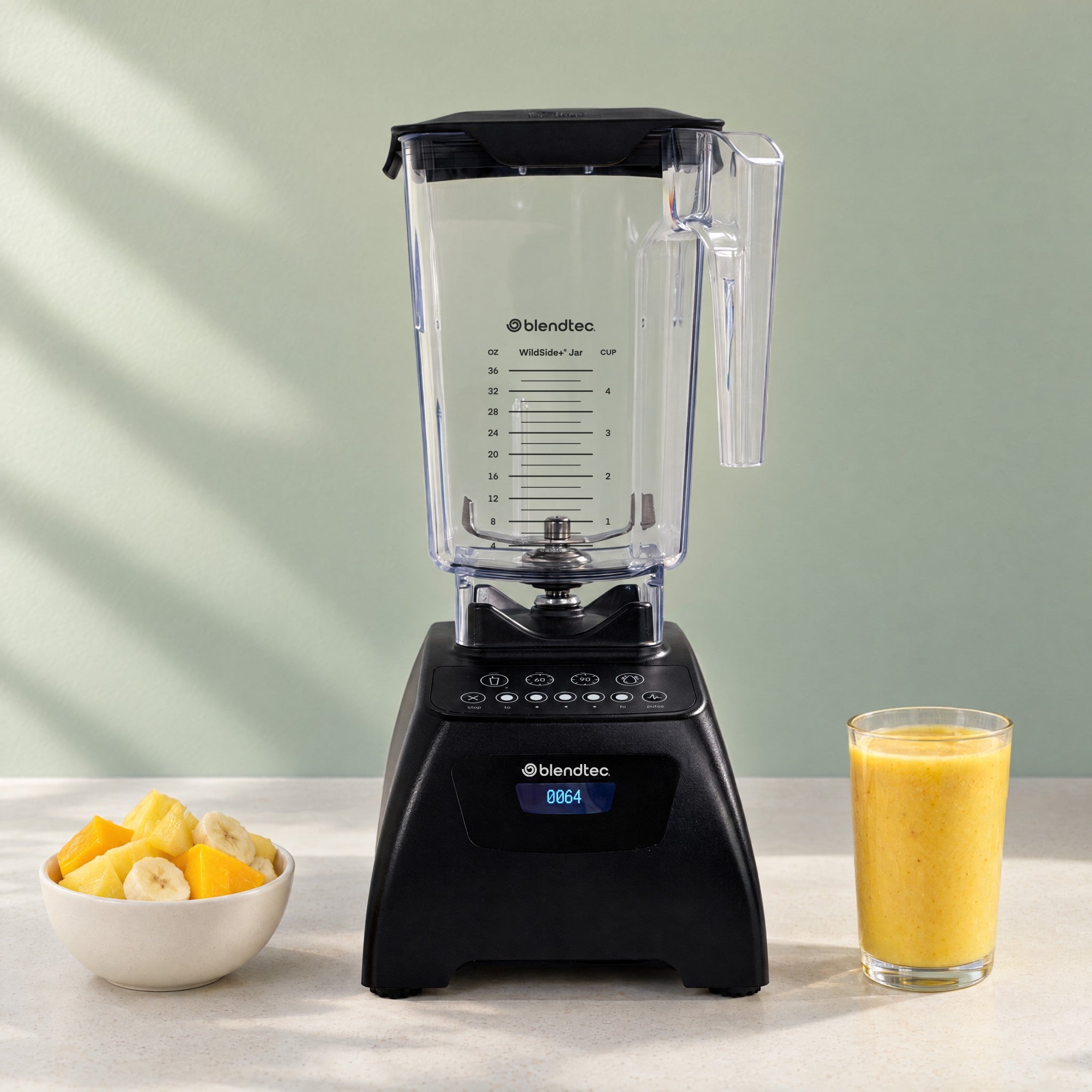 Black Classic 575 with WildSide+ jar; staged fruit and smoothie are scene props.